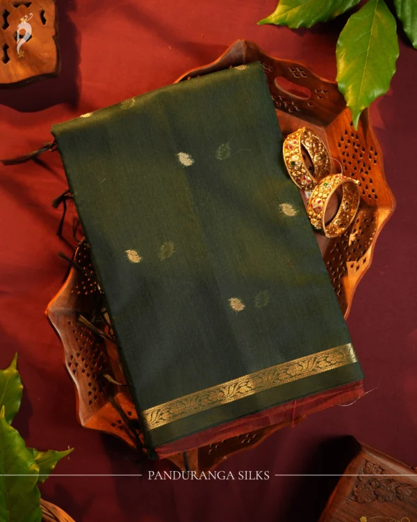 Dark Green Soft Silk Cotton Saree with Golden Zari Buttas Design Dark green silk cotton saree with golden zari buttas and detailed zari border