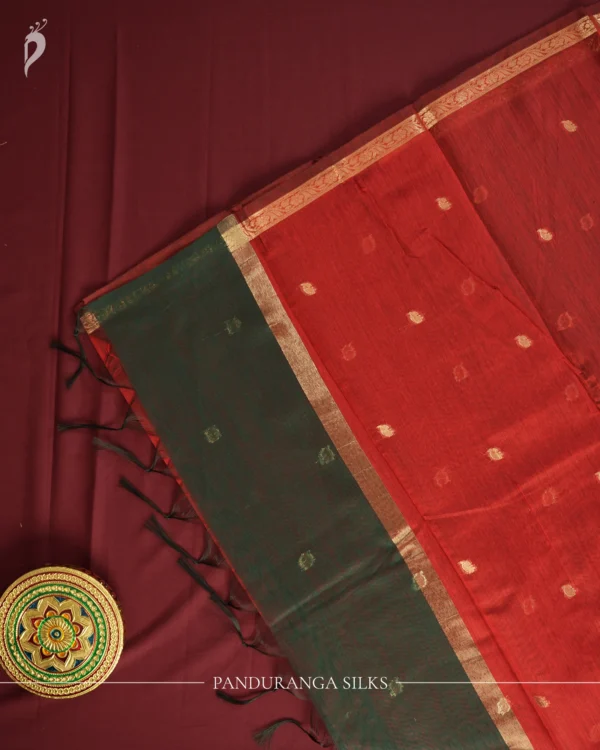Dark Green Soft Silk Cotton Saree with Golden Zari Buttas Design Dark green silk cotton saree with golden zari buttas and detailed zari border