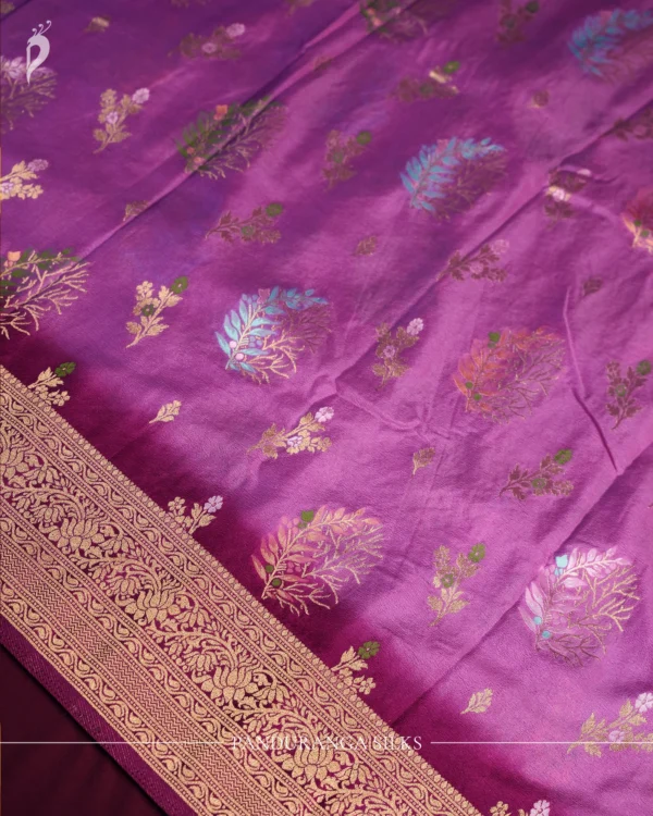 Pistachio and bottle green georgette silk saree with floral zari buttas, golden zari border and tassel pallu