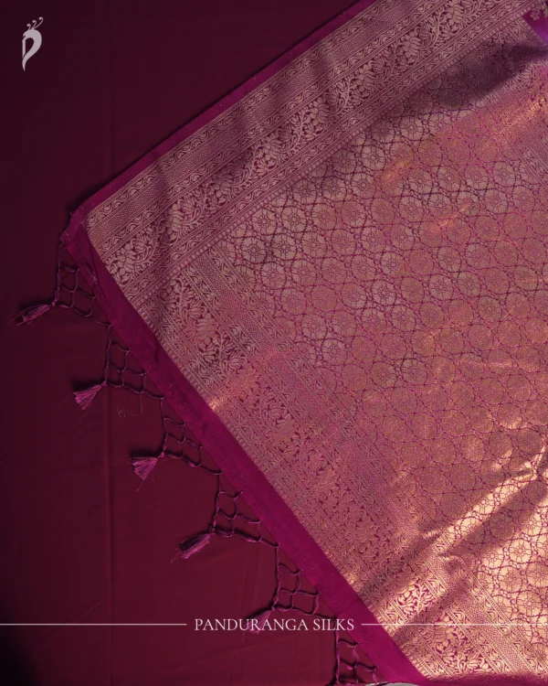 Pistachio and bottle green georgette silk saree with floral zari buttas, golden zari border and tassel pallu