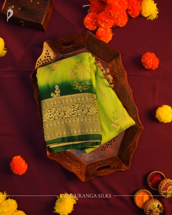 Green Georgette Silk Saree with Floral Buttas and Golden Zari Border Green georgette silk saree with floral zari buttas, golden zari border, floral motifs and tassel pallu
