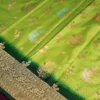 Green Georgette Silk Saree with Floral Buttas and Golden Zari Border Green georgette silk saree with floral zari buttas, golden zari border, floral motifs and tassel pallu