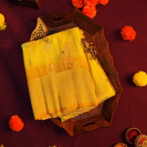 Lemon yellow georgette silk saree with floral zari buttas, golden zari border, floral motifs and tassel pallu