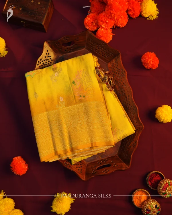 Lemon yellow georgette silk saree with floral zari buttas, golden zari border, floral motifs and tassel pallu