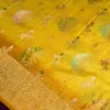 Lemon yellow georgette silk saree with floral zari buttas, golden zari border, floral motifs and tassel pallu