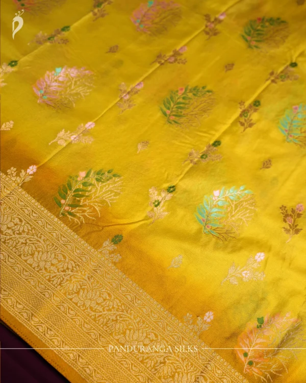 Lemon yellow georgette silk saree with floral zari buttas, golden zari border, floral motifs and tassel pallu