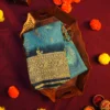 Turquoise Blue Georgette Silk Saree with Golden Floral Zari Work Turquoise blue georgette silk saree with floral zari buttas, golden zari border, teal shade and tassel pallu