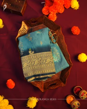 Turquoise Blue Georgette Silk Saree with Golden Floral Zari Work Turquoise blue georgette silk saree with floral zari buttas, golden zari border, teal shade and tassel pallu