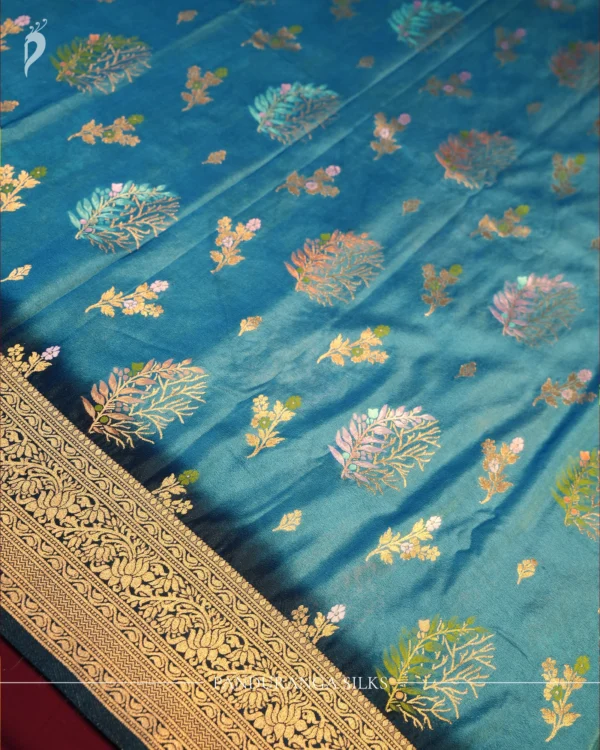 Turquoise Blue Georgette Silk Saree with Golden Floral Zari Work Turquoise blue georgette silk saree with floral zari buttas, golden zari border, teal shade and tassel pallu