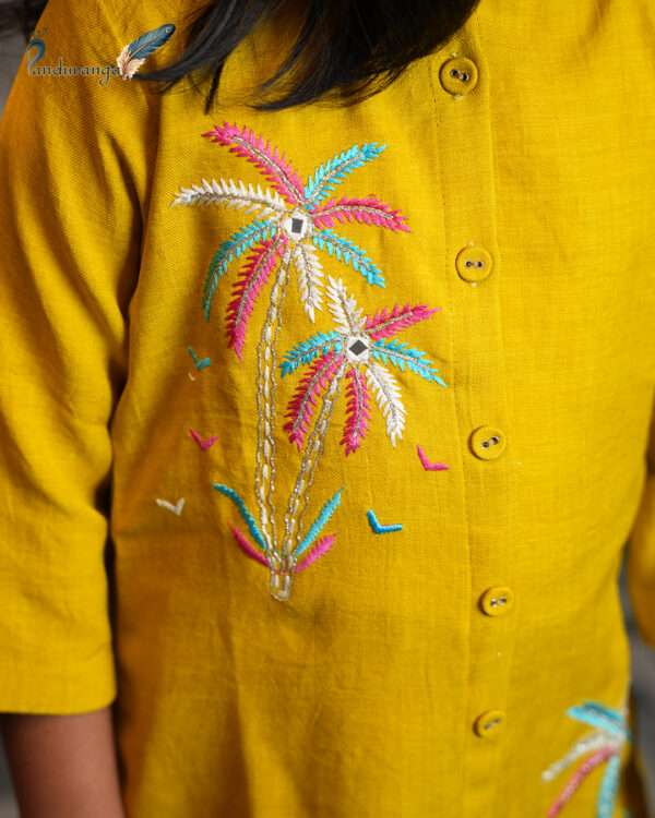 Mustard yellow girls' kurti set with colourful embroidered motifs on the kurti and pants. Mustard yellow girls' kurti set with colourful embroidered motifs on the kurti and pants.