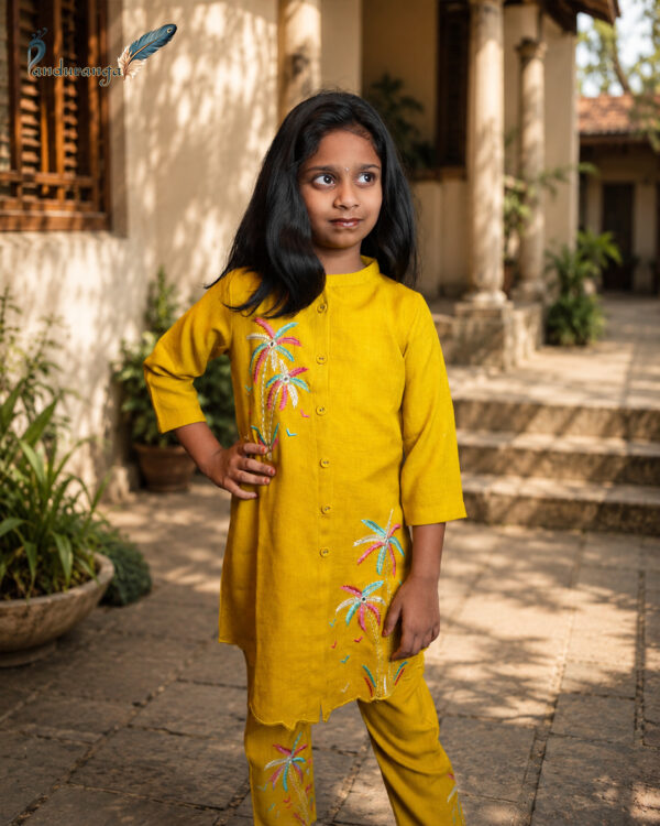 Mustard yellow girls' kurti set with colourful embroidered motifs on the kurti and pants. Mustard yellow girls' kurti set with colourful embroidered motifs on the kurti and pants.